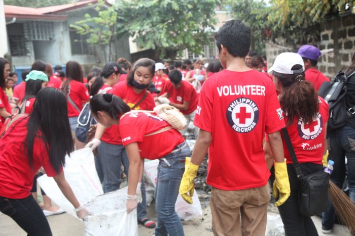 Philippine Red Cross volunteers take to the streets to clean up after the Manila floods. From emergency relief to the post-flood clean-up, Philippine Red Cross volunteers where involved. Photo: Joe Cropp/IFRC