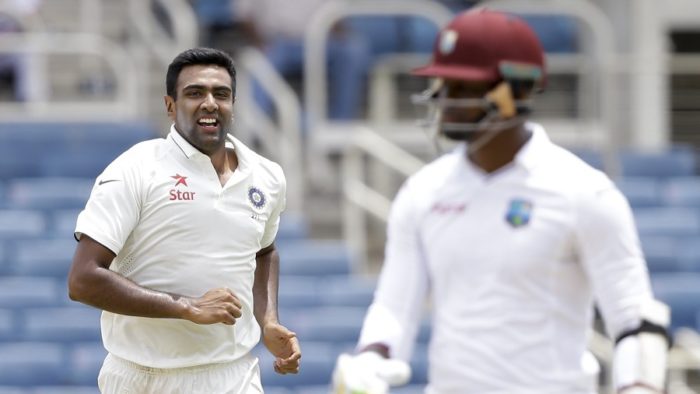 India's Ravichandran Ashwin, left, celebrates taking the wicket of West Indies' Marlon Samuels, right, during day one of their second cricket Test match at the Sabina Park Cricket Ground in Kingston, Jamaica, Saturday, July 30, 2016. (AP Photo/Ricardo Mazalan)