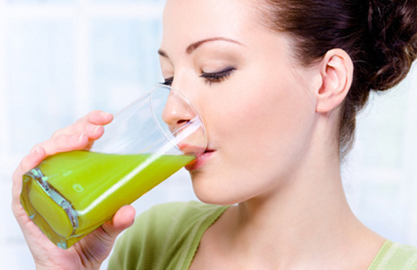 Beautiful young girl drinking fresh orange juice